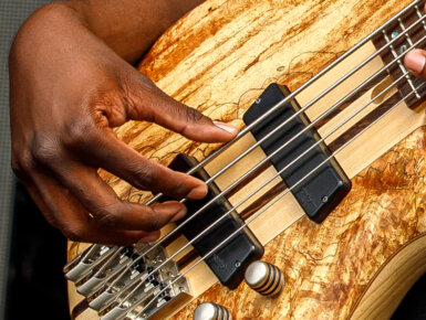 hand playing Cort bass guitar