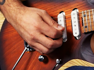 hand strumming Cort electric guitar